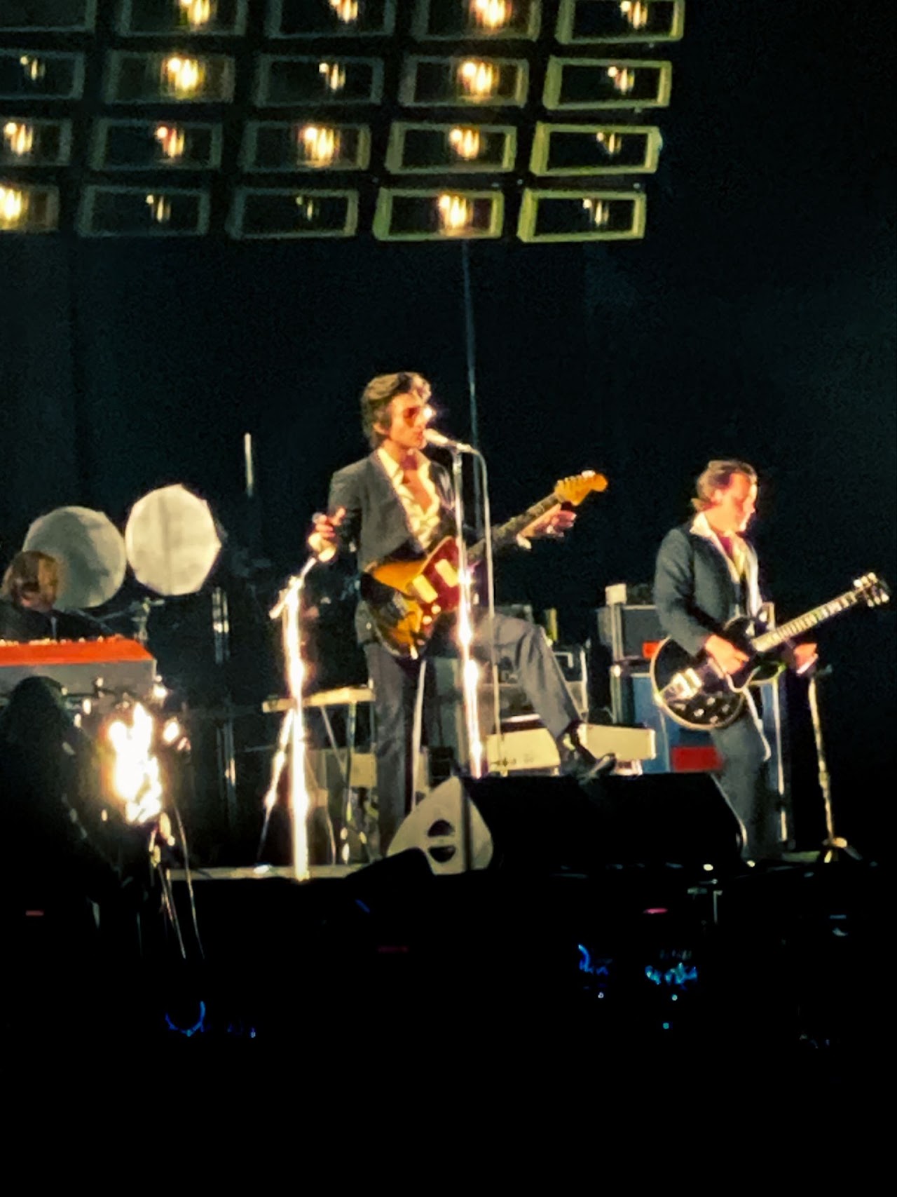 Arctic Monkeys performing live, photographed by Ludovic Delot