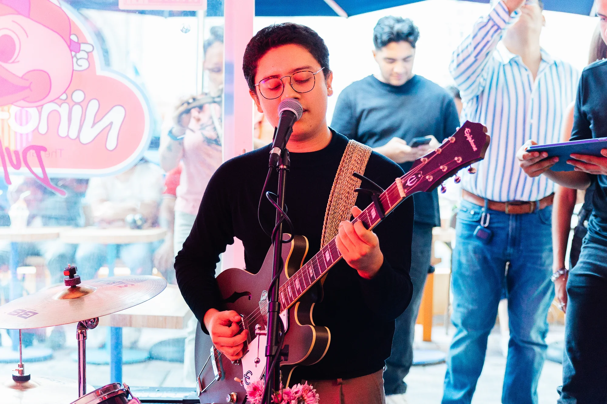 A guitarist playing with the band, photographed by Ludovic Delot
