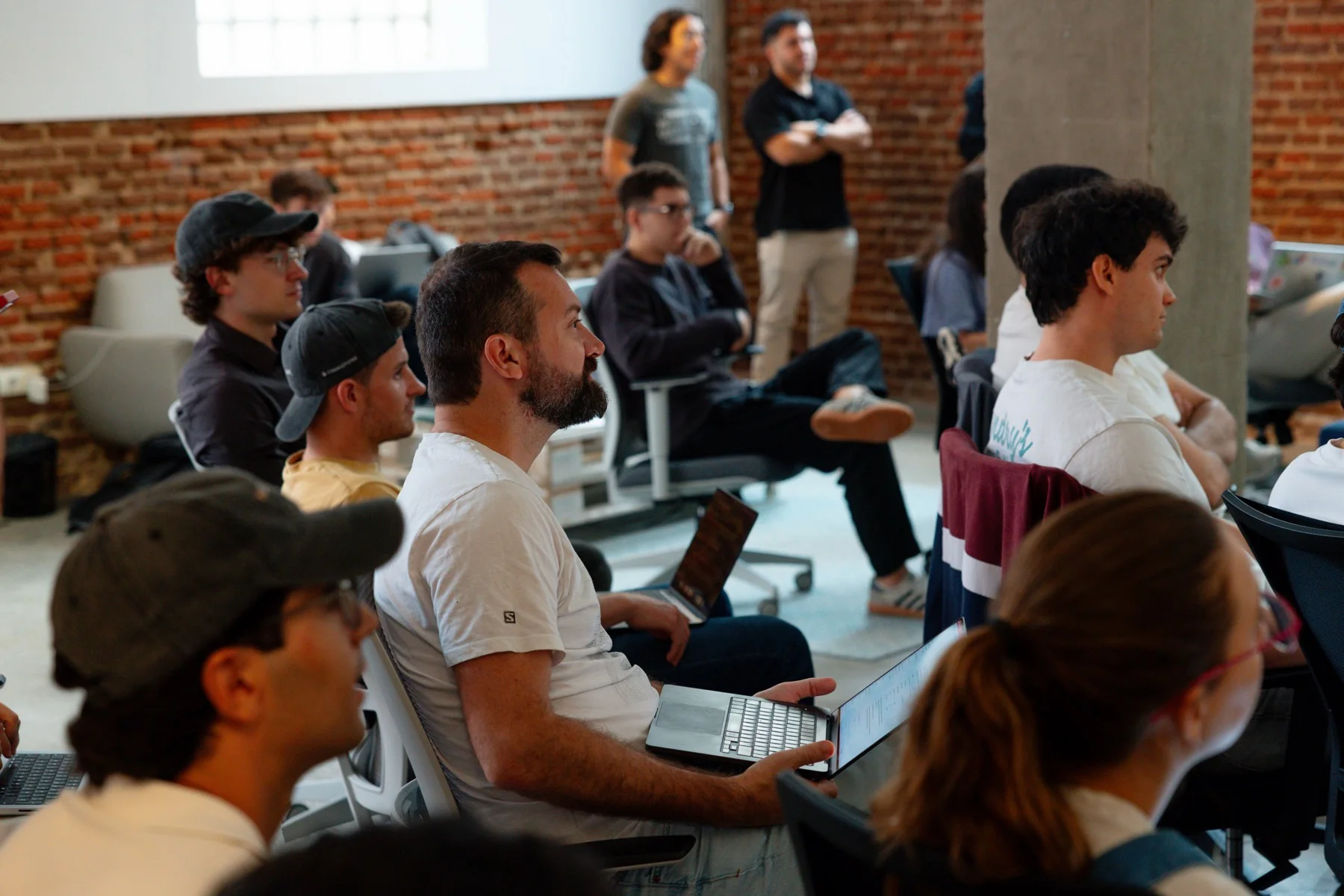 Participants gather for a shared presentation at the Claude Community Madrid Hackathon, photographed by Ludovic Delot