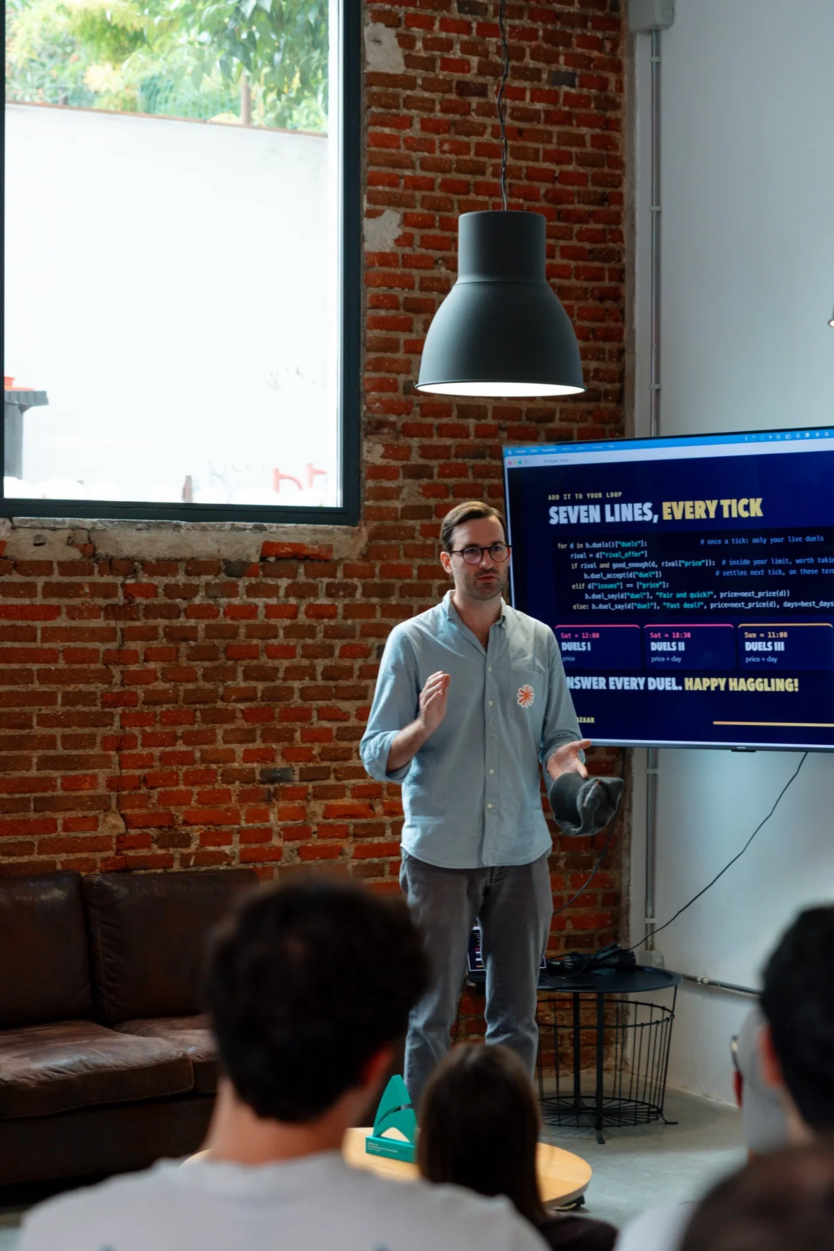 Presenting work in progress at the Claude Community Madrid Hackathon, photographed by Ludovic Delot