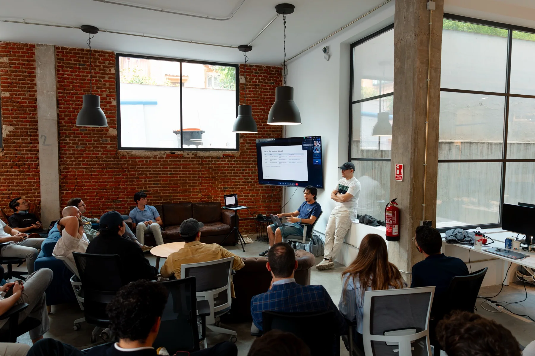 A conversation around a live demo at the Claude Community Madrid Hackathon, photographed by Ludovic Delot