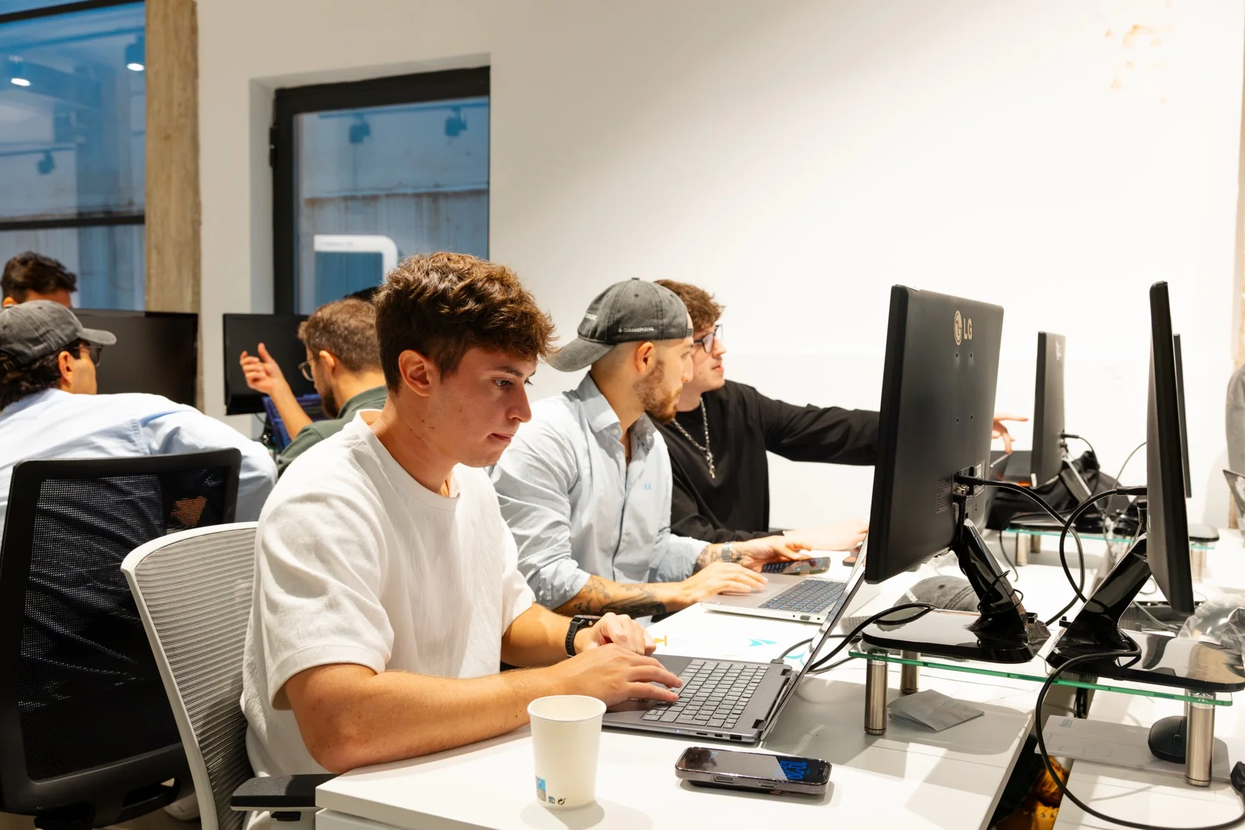Ludovic Delot working with teammates during the Claude Community Madrid Hackathon