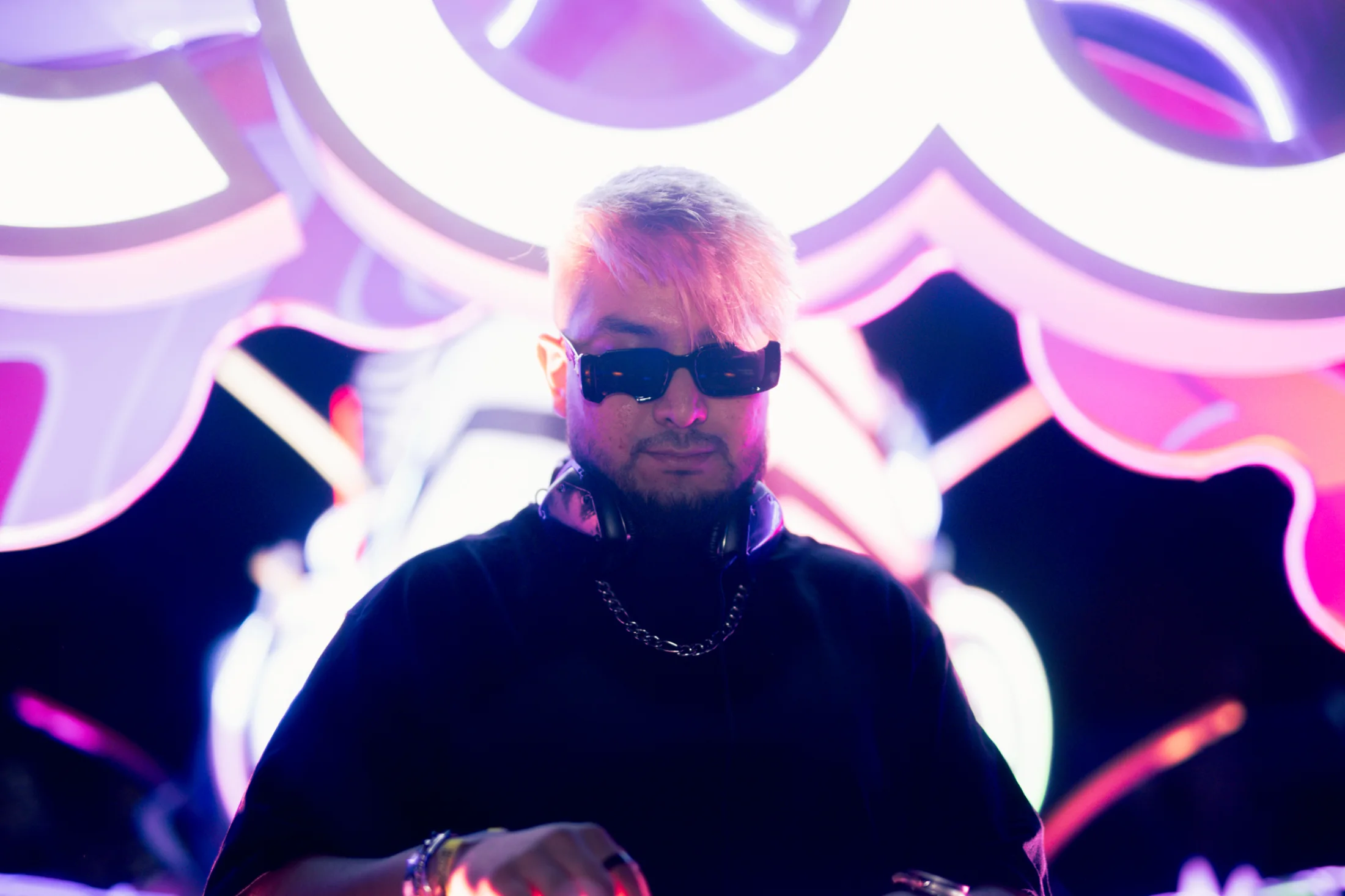OLSE performing beneath the glowing EDC Mexico art car.