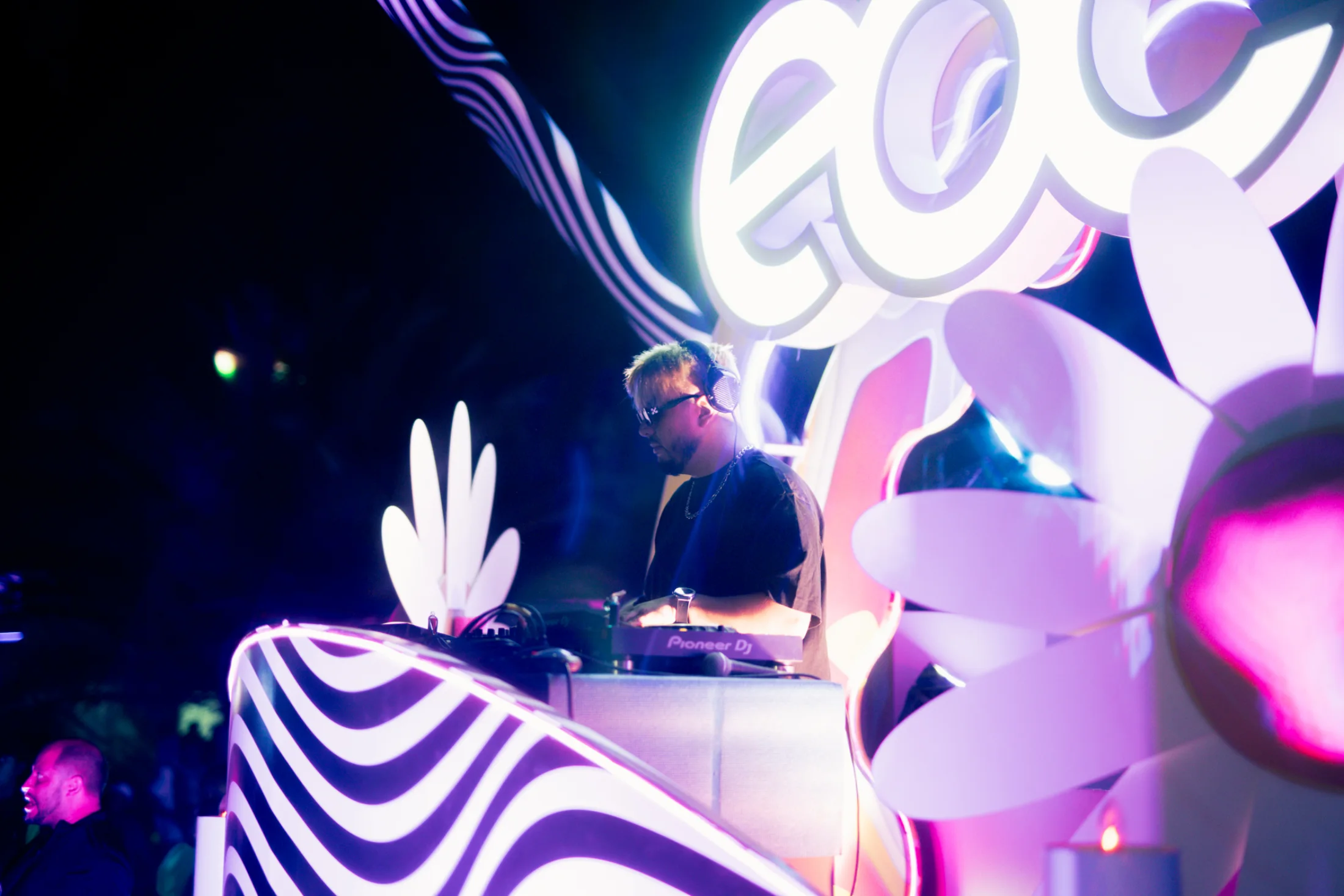 A wide view of OLSE at the decks with the festival installation behind him.
