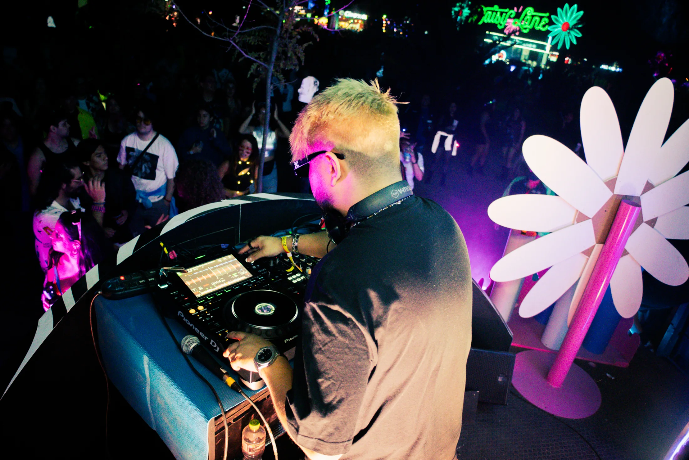 A view across the DJ booth toward the audience.
