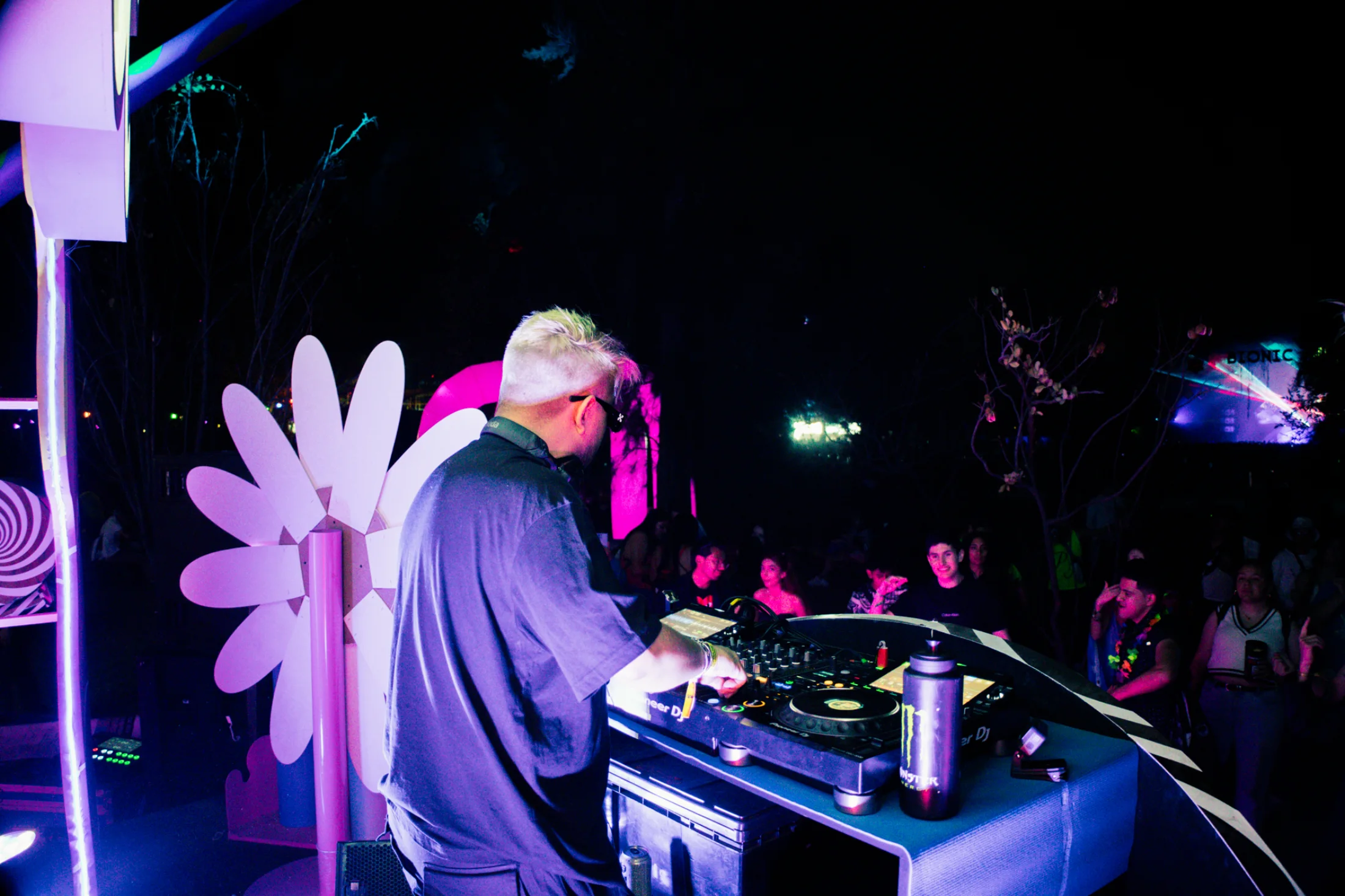 OLSE at the booth with the crowd beyond him.
