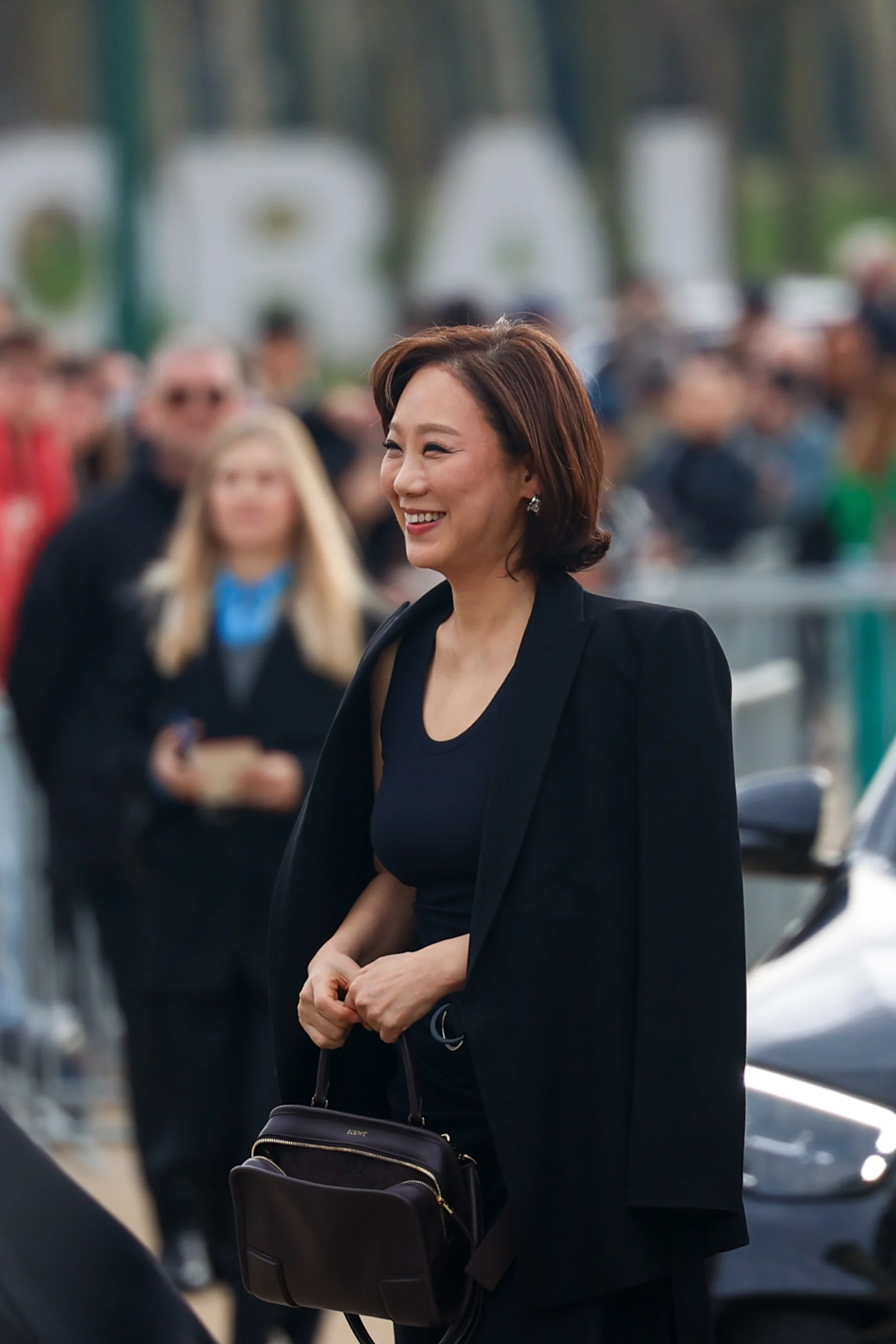 Street-style photograph outside the LOEWE FW26 show during Paris Fashion Week, frame 02 of 34, photographed by Ludovic Delot