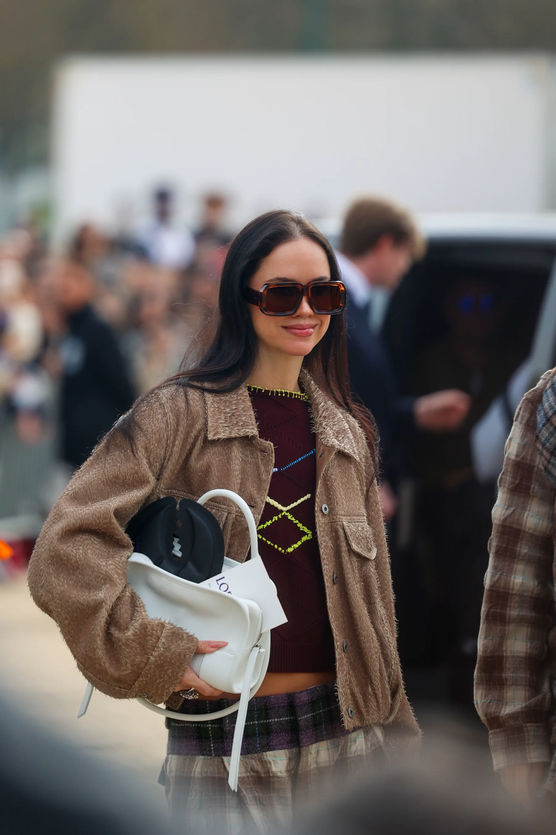 Street-style photograph outside the LOEWE FW26 show during Paris Fashion Week, frame 11 of 34, photographed by Ludovic Delot