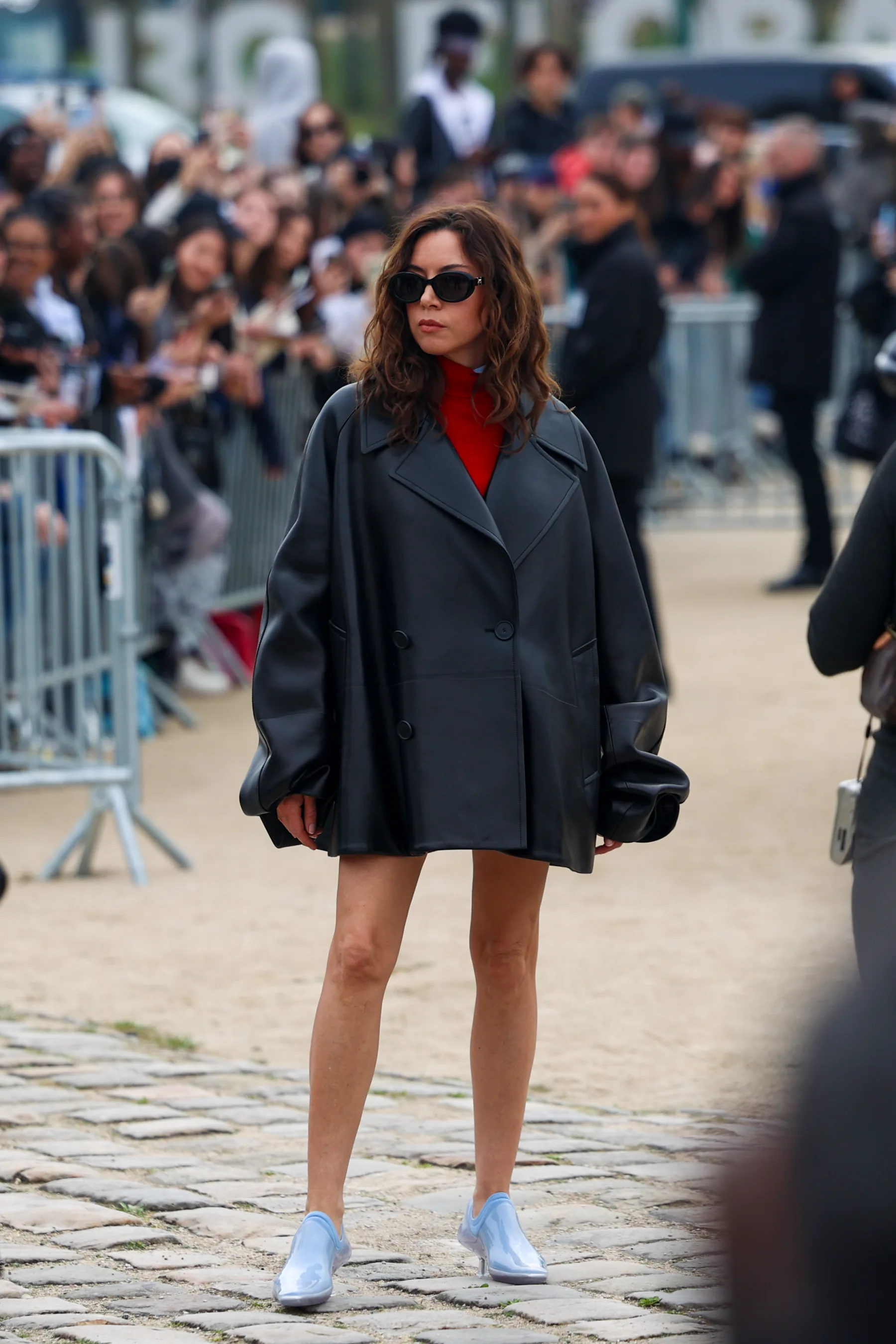Street-style photograph outside the LOEWE FW26 show during Paris Fashion Week, frame 24 of 34, photographed by Ludovic Delot
