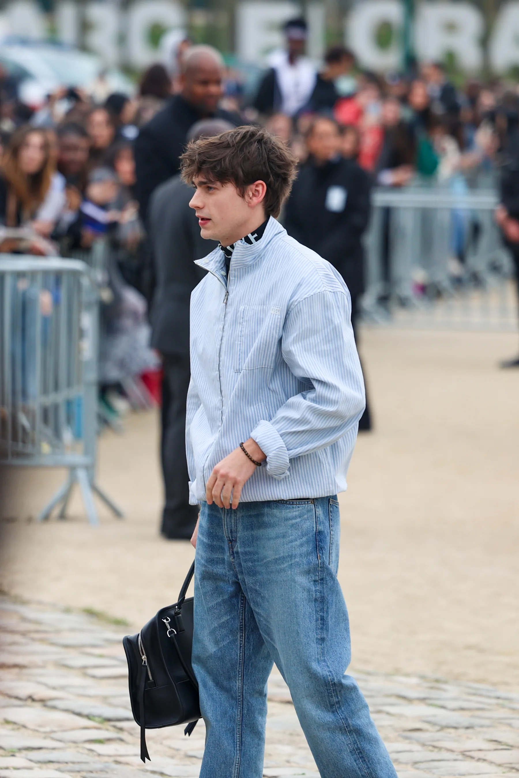 Street-style photograph outside the LOEWE FW26 show during Paris Fashion Week, frame 27 of 34, photographed by Ludovic Delot