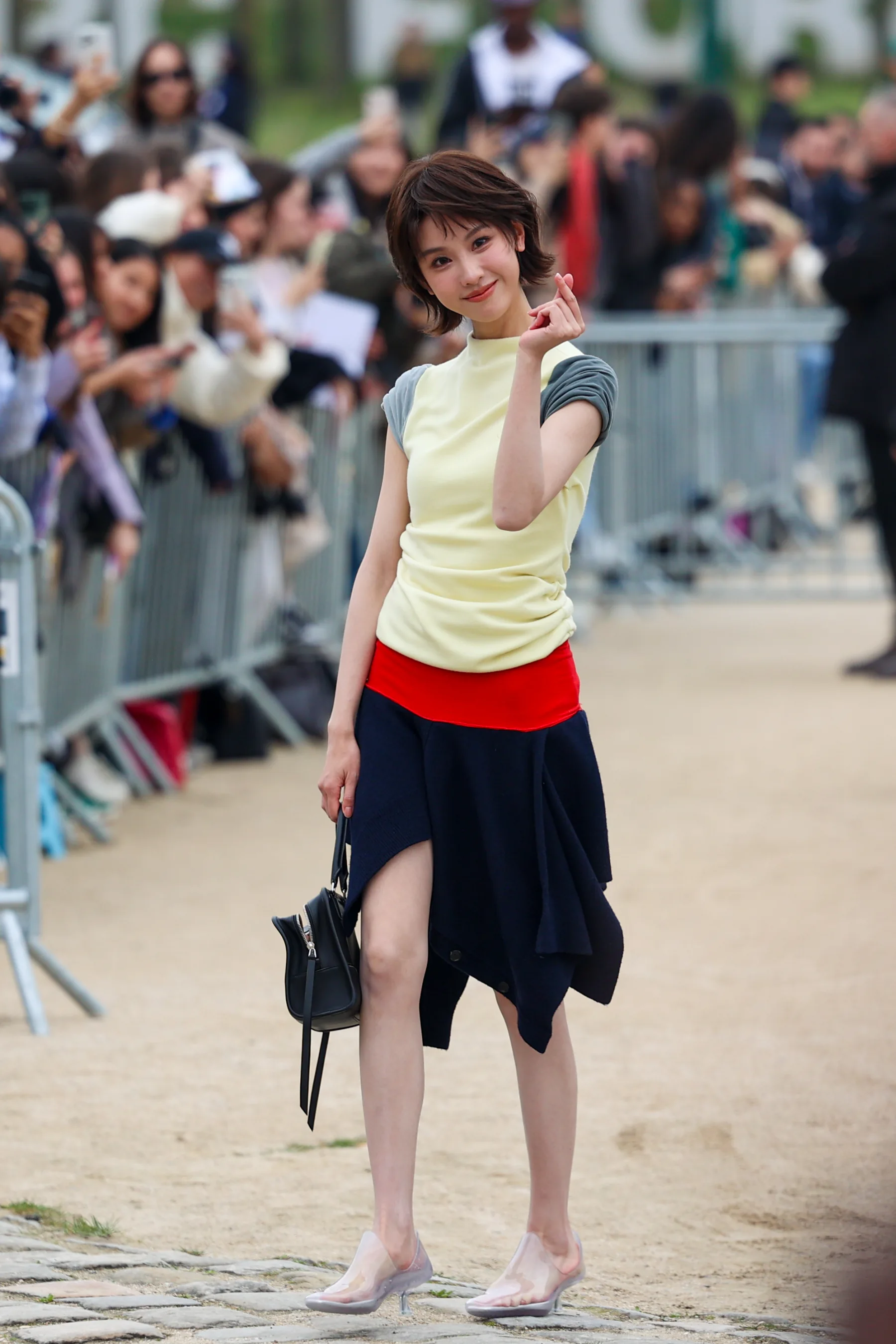 Street-style photograph outside the LOEWE FW26 show during Paris Fashion Week, frame 34 of 34, photographed by Ludovic Delot