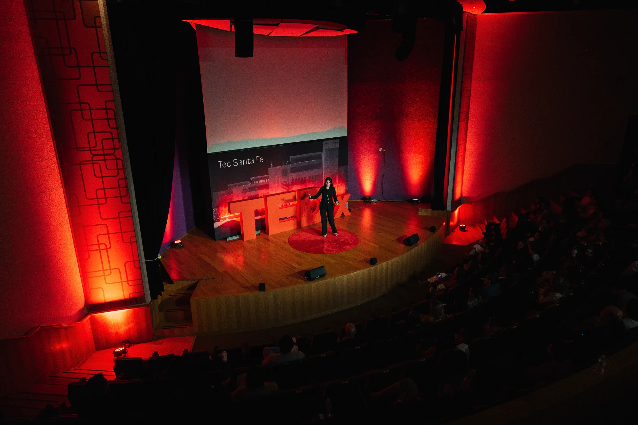 Speaker on the red TEDx stage at Tecnológico de Monterrey campus Santa Fe